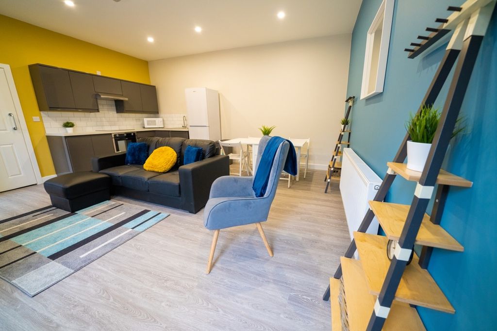 Property photo 1 of 8 Bright And Stylish Living Room Featuring Modern Fu...