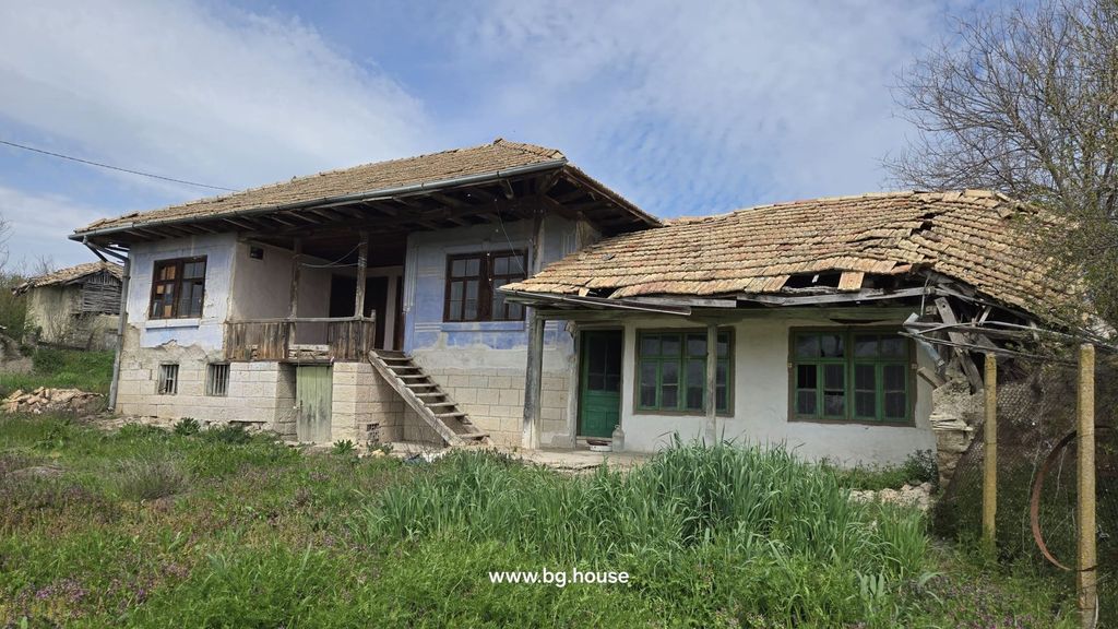Property photo 1 of 48 Exterior View Of A Traditional Bulgarian House Showing Stone Basement, Wooden Balcony, Tiled Roof, And Green Doors And Windows.