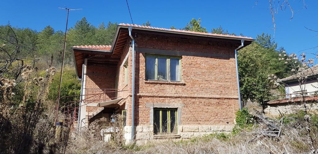 Property photo 2 of 73 Side View Showing Green Window Frames And Tiled Roof Of The Brick House In A Rural Area