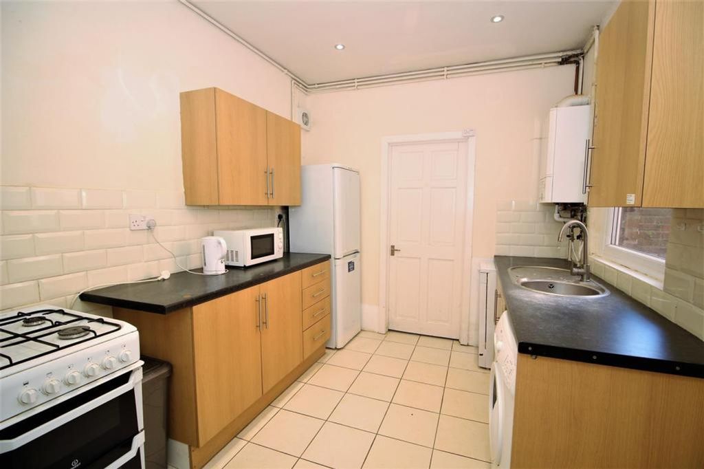 Property photo 3 of 5 Bright And Modern Kitchen Featuring Ample Storage ...