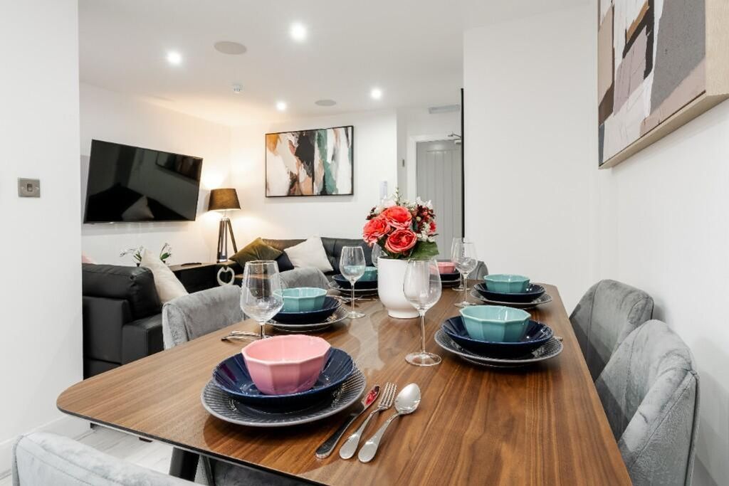 Property photo 3 of 15 A Stylish Living Room Featuring A Modern Dining Ta...