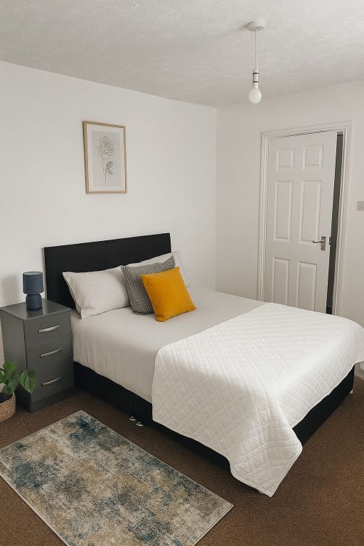Property photo 1 of 8 A Bright, Neatly Made Bedroom Featuring A Comforta...
