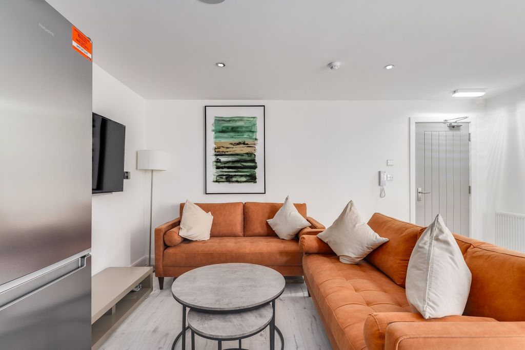 Property photo 2 of 7 Modern And Inviting Living Room With Warm Orange S...
