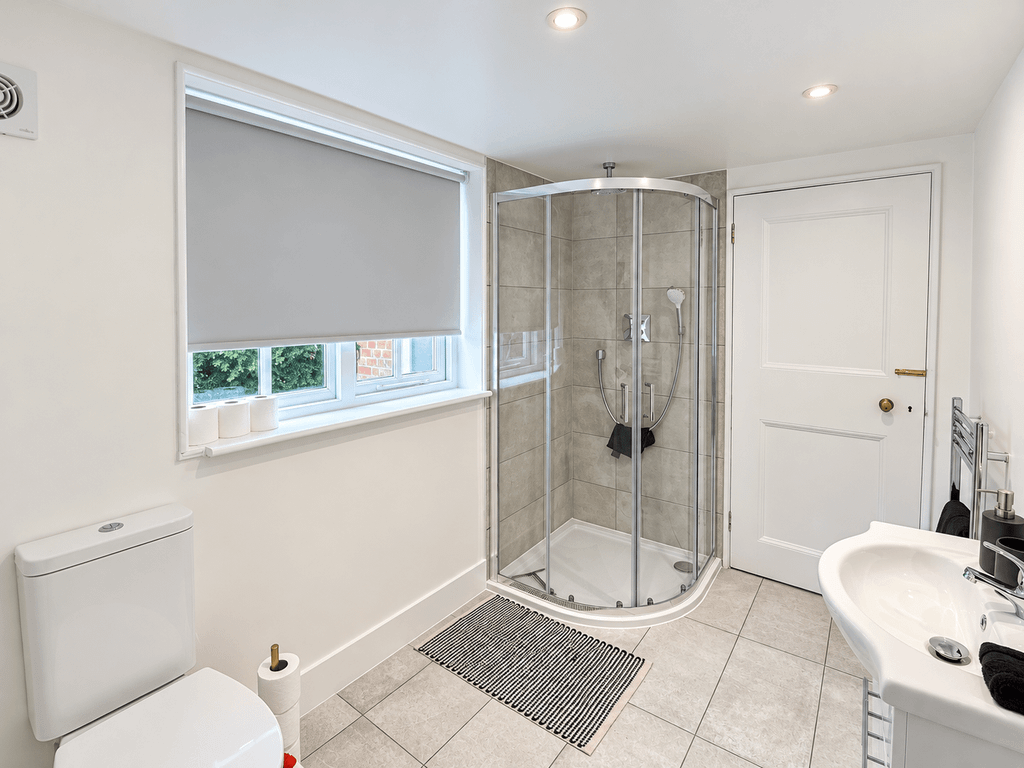 Property photo 2 of 17 Bright, Balanced Bathroom With Curved Shower