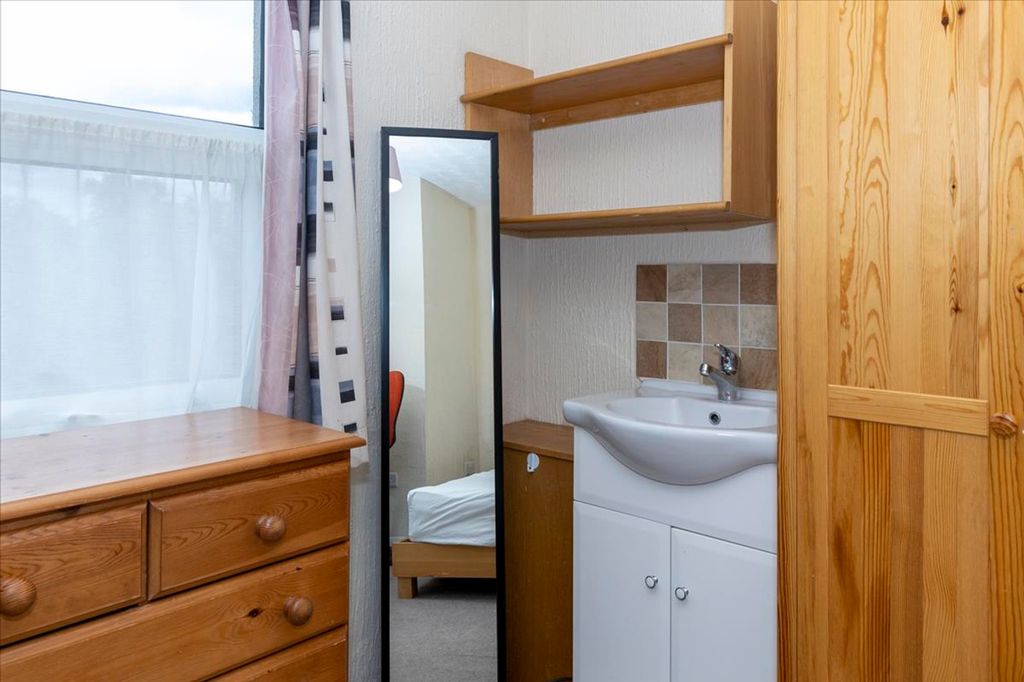 Property photo 2 of 13 A Cozy Double Bedroom Featuring A Stylish Wooden d...