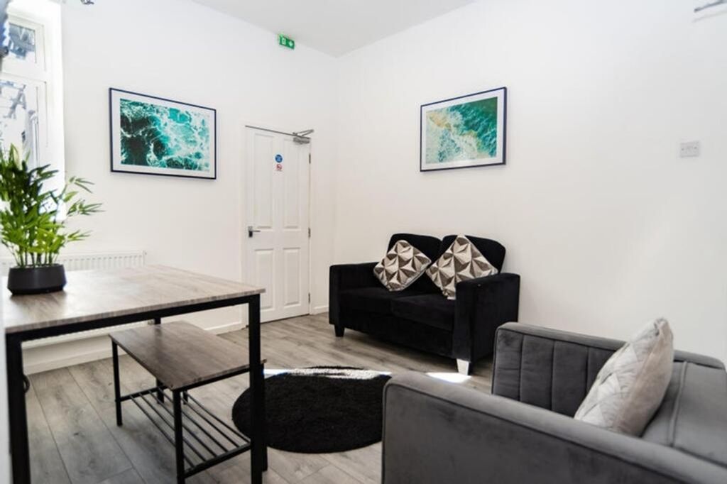 Property photo 1 of 12 A Bright And Inviting Living Room Featuring Modern...