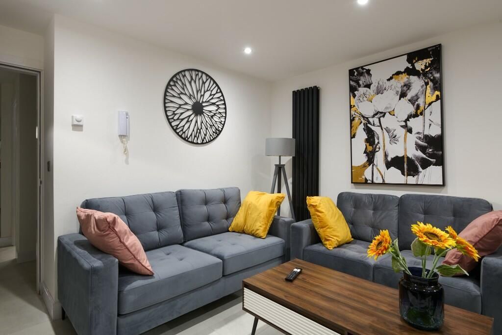 Property photo 3 of 9 A Modern And Inviting Living Room Featuring A Larg...