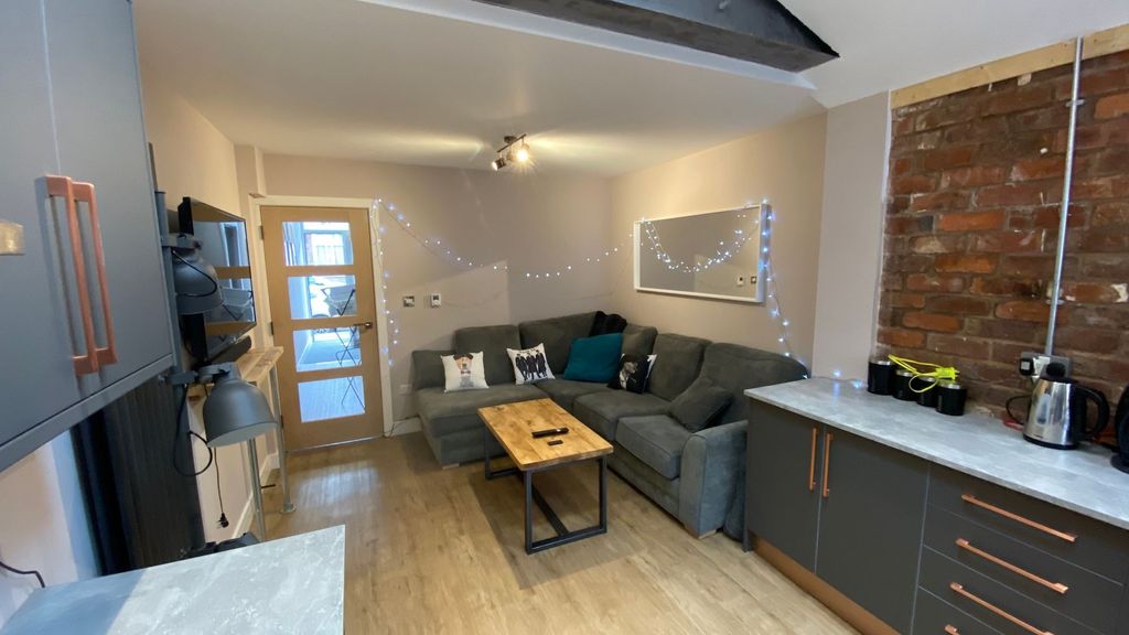Property photo 3 of 6 A Cozy And Welcoming Living Room Featuring A Comfo...