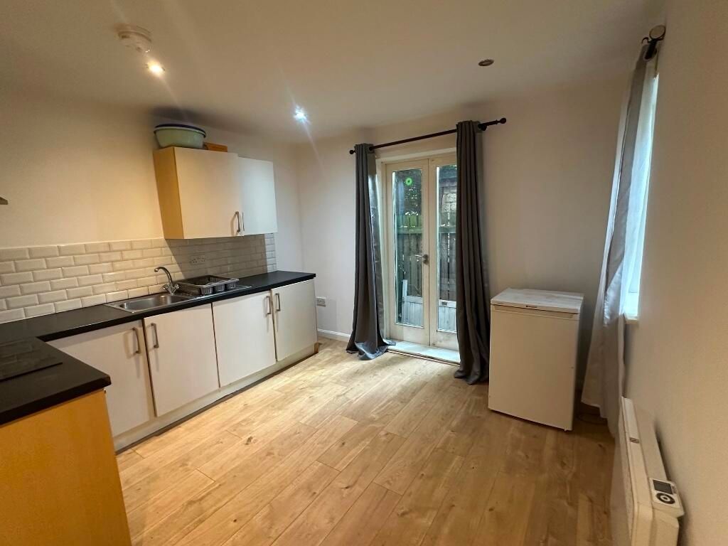 Property photo 1 of 6 Bright And Clean Kitchen Featuring Modern Cabinetr...