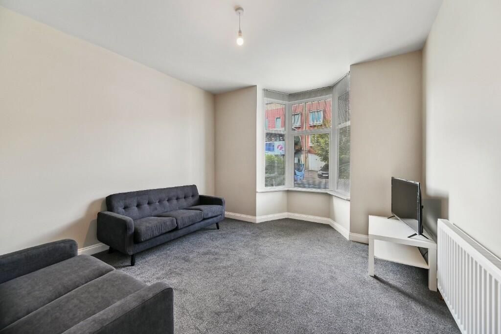 Property photo 3 of 15 A Comfortable Living Room Featuring Two Dark Sofas...