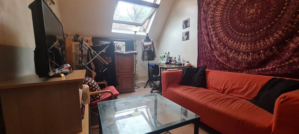 Property photo 3 of 9 A Cozy, Well-Lit Living Room Featuring A Comfortab...