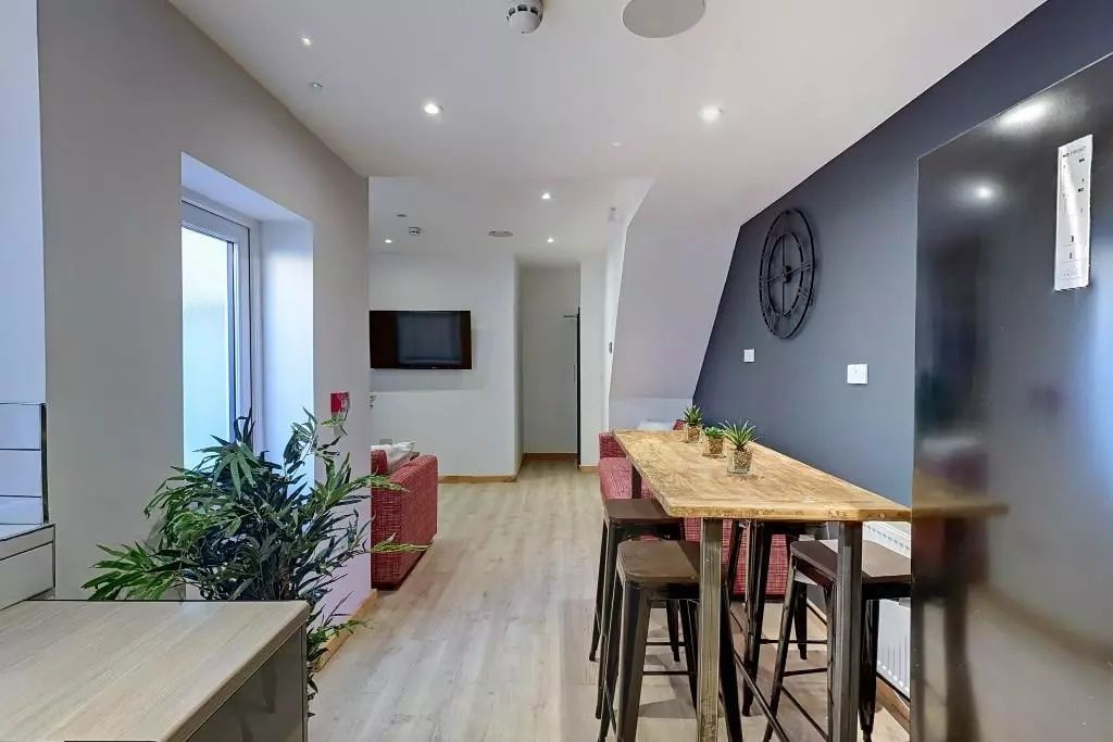 Property photo 3 of 9 A Modern Communal Lounge Featuring A Sleek Wooden ...