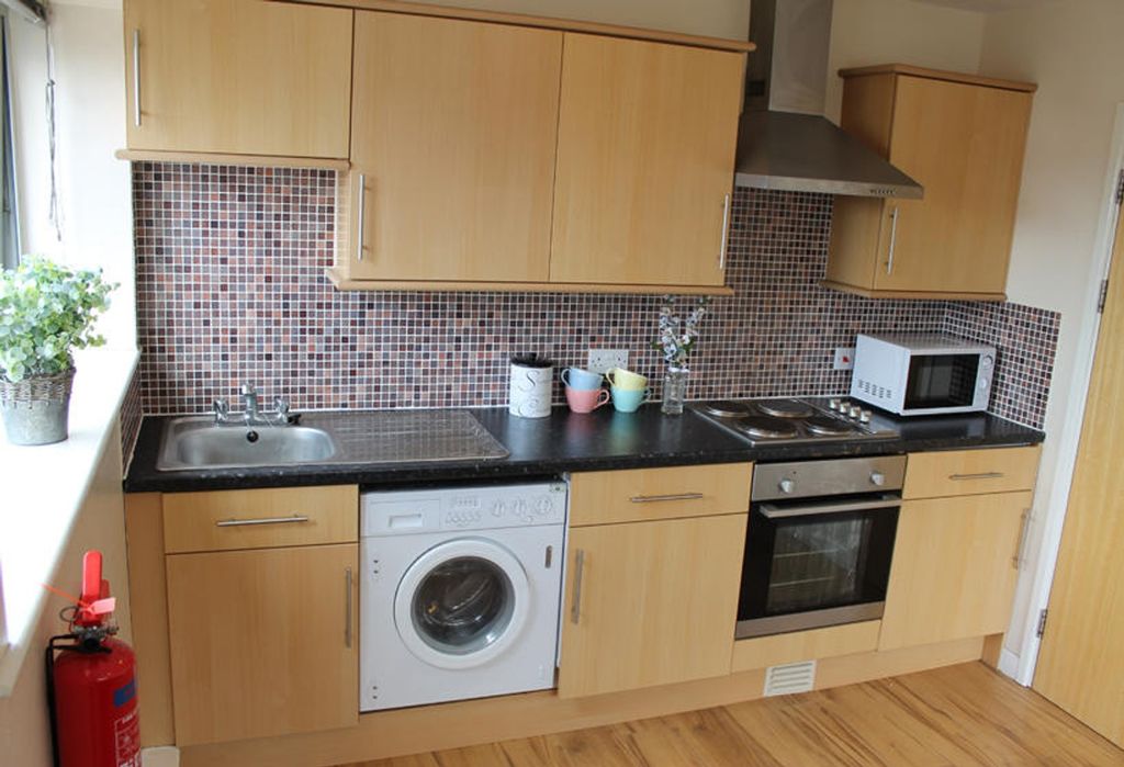 Property photo 3 of 7 This Modern Kitchen Features Stylish Cabinetry And...