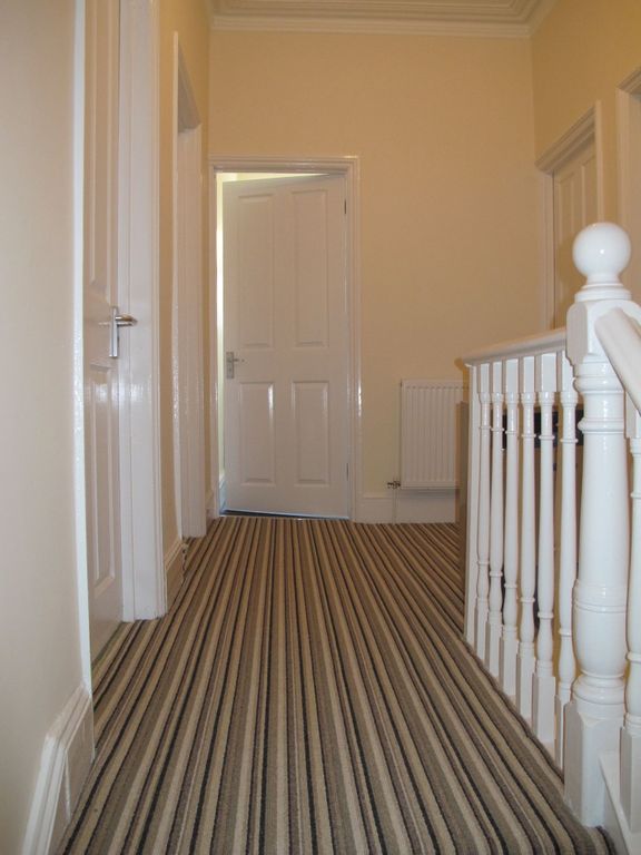 Property photo 2 of 8 Bright, Well-Maintained Upstairs Hallway With Stri...