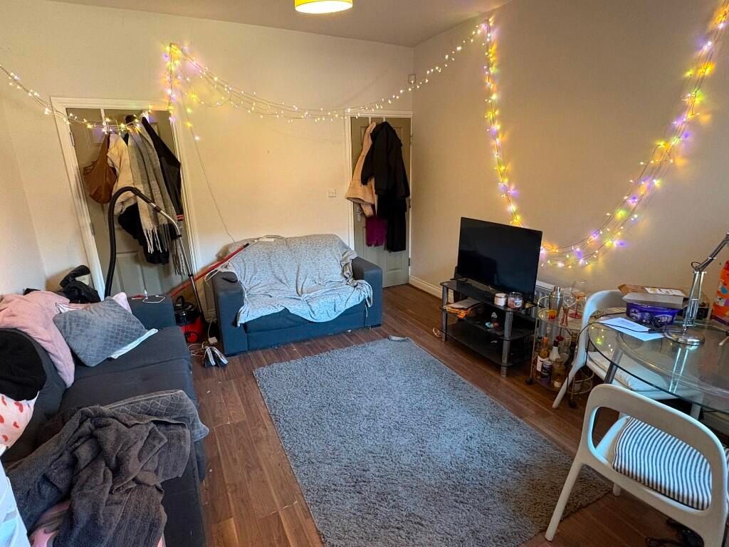 Property photo 3 of 11 A Cozy And Inviting Living Room Featuring Warm Woo...