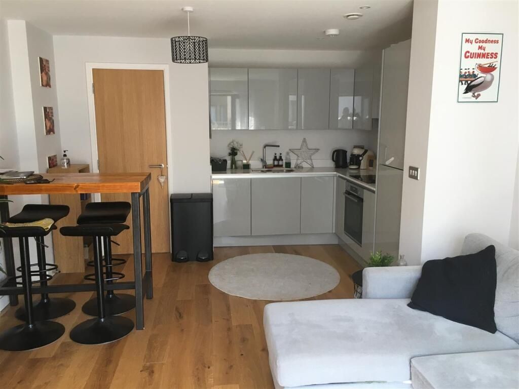 Property photo 3 of 8 Bright And Modern Living Room Featuring A Sleek Ki...