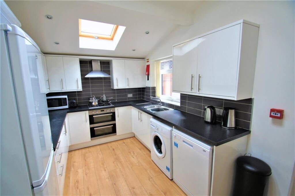 Property photo 3 of 12 Bright And Modern Kitchen Featuring Sleek Cabinetr...