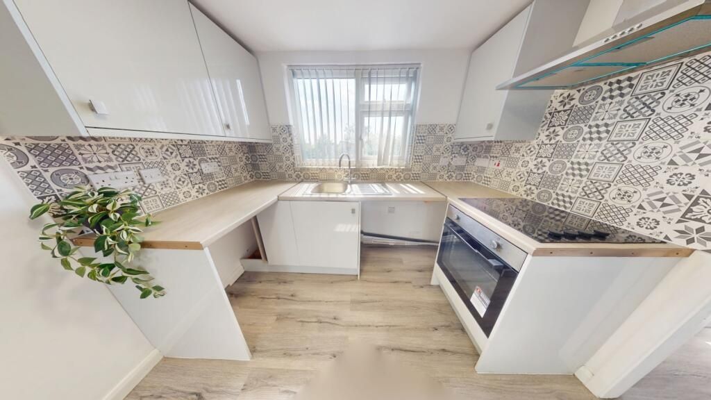 Property photo 2 of 12 Bright And Modern Kitchen Featuring A Stylish Tile...