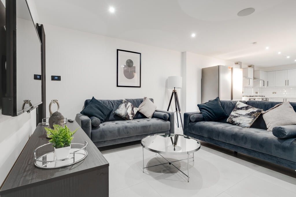 Property photo 2 of 14 A Modern, Spacious Living Room Featuring Two Large...