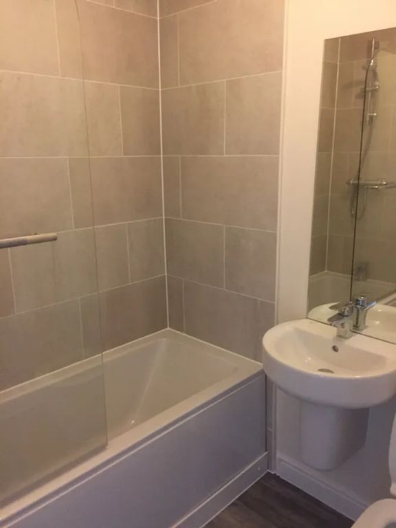 Property photo 3 of 8 A Modern Bathroom Featuring A Sleek Design With Bo...