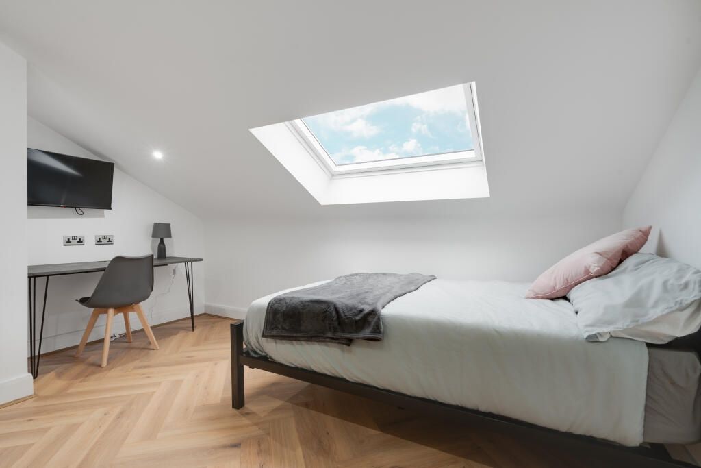 Property photo 1 of 12 A Bright And Modern Master Bedroom Featuring A Com...