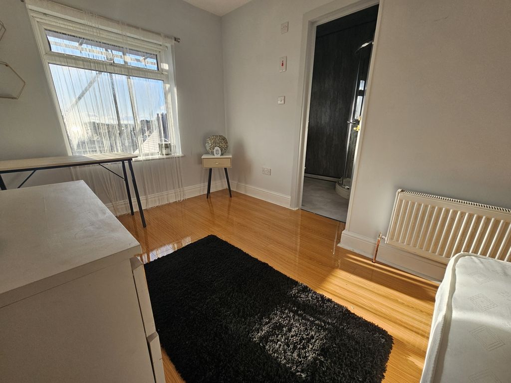 Property photo 2 of 21 A Spacious And Well-Lit Master Bedroom With Wooden...