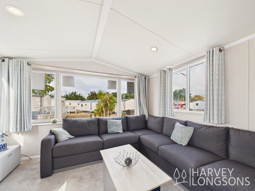 Property photo 2 of 12 Spacious Lounge With Large Corner Seating And Windows.