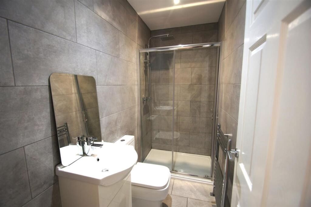 Property photo 2 of 12 A Modern And Stylish Bathroom Featuring Elegant St...