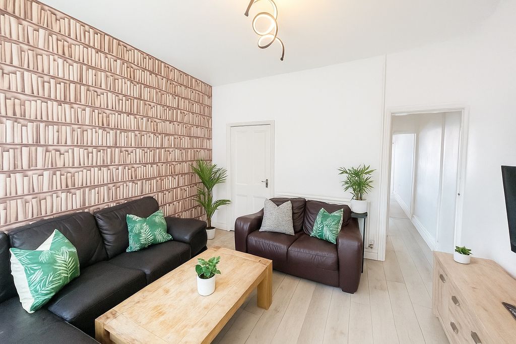 Property photo 2 of 6 A Modern And Inviting Living Room Featuring Comfor...