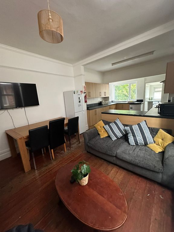 Property photo 2 of 22 A Spacious, Well-Lit Living Room Featuring A Comfo...