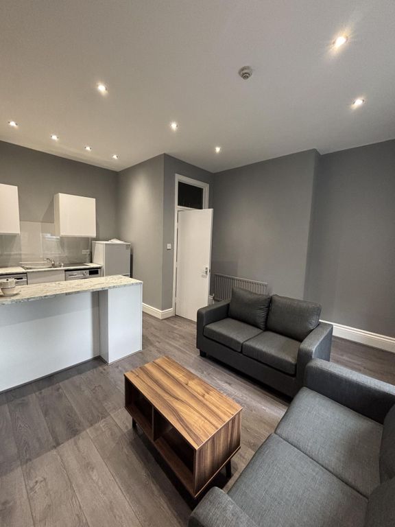 Property photo 2 of 28 A Modern And Well-Lit Living Room Featuring A Comf...