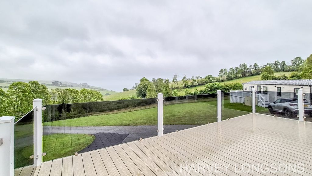 Property photo 2 of 21 Decking Area With Glass Balustrade And Open Countryside Views From Delta Lakeside Lodge In Cornwall