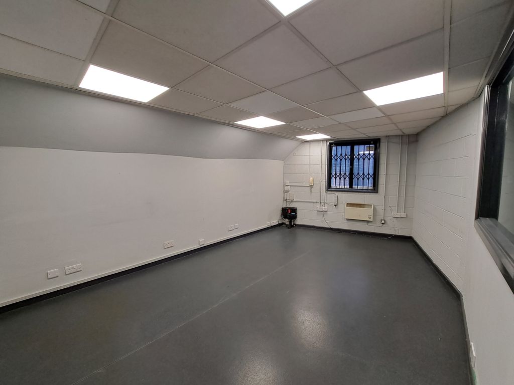 Property photo 3 of 6 An Empty Arch With White Lining, Facing The Front Electric Roller Shutter Entrance, Which Is Closed.