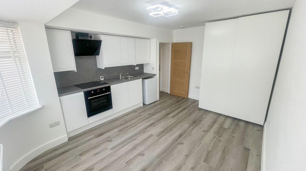 Property photo 1 of 4 Bright And Modern Kitchen Area Featuring Sleek Whi...