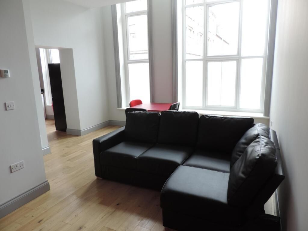 Property photo 2 of 4 Bright Living Area With Large Windows And Sofa...