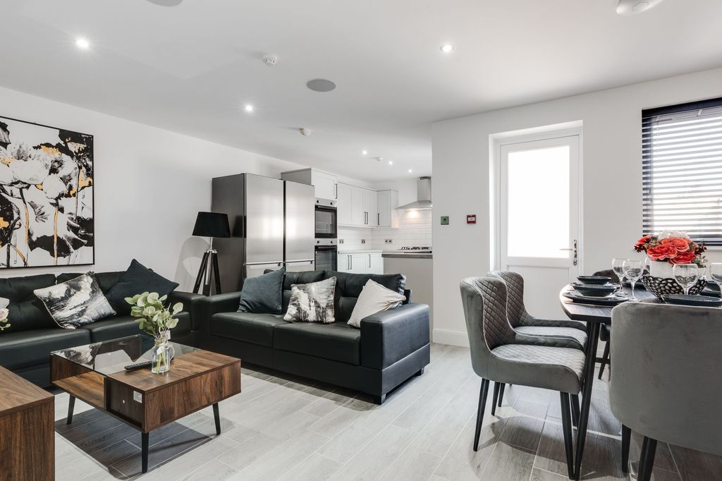 Property photo 1 of 7 Modern, Spacious Living Room Featuring Comfortable...