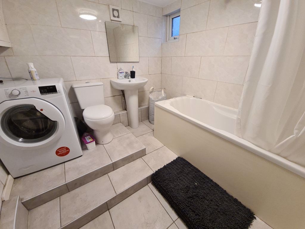 Property photo 2 of 4 Bright, Tiled Bathroom With A Bathtub And Separate...