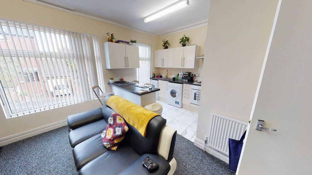 Property photo 2 of 9 Bright And Cozy Living Room Featuring A Large Wind...