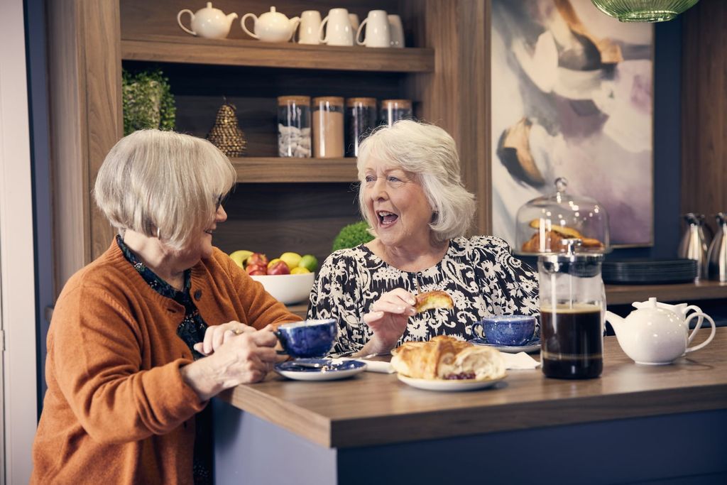 Property photo 3 of 15 A Person And An Old Woman Eating At A Table