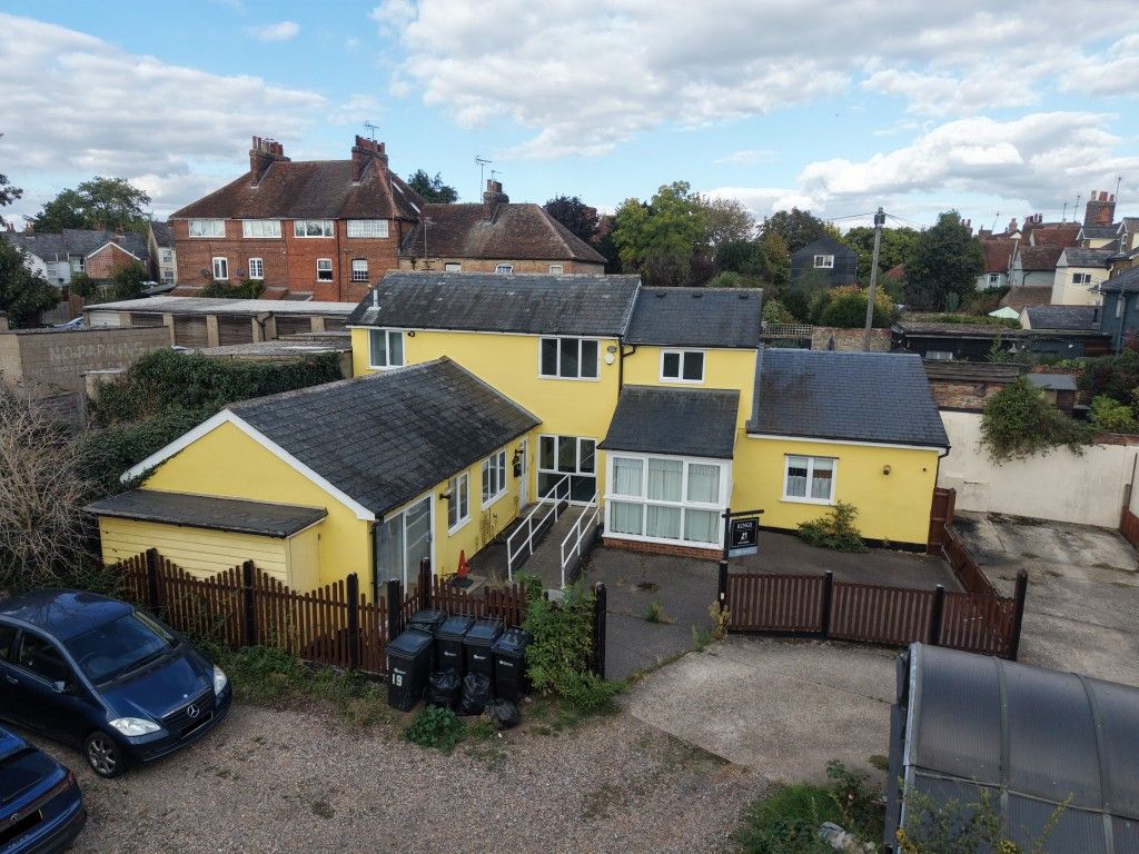 Property photo 1 of 14 Front Aerial View Of Building With Fenced Parking