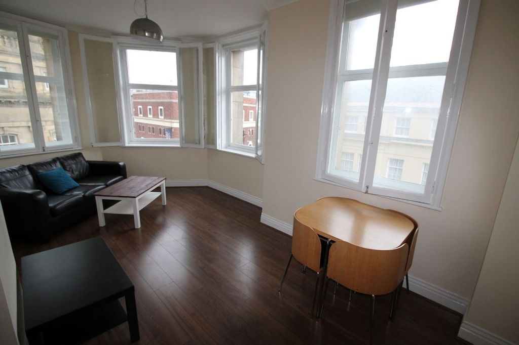 Property photo 3 of 8 Bright And Inviting Living Room Featuring Large Wi...