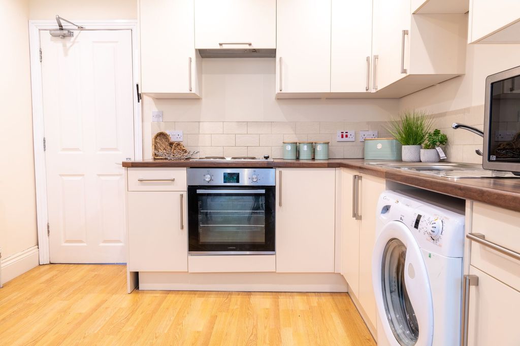 Property photo 3 of 11 Bright, Modern Kitchen With White Cabinets, Wood-E...