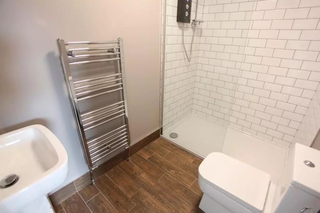 Property photo 3 of 12 Modern Bathroom Featuring A Sleek Walk-In Shower W...