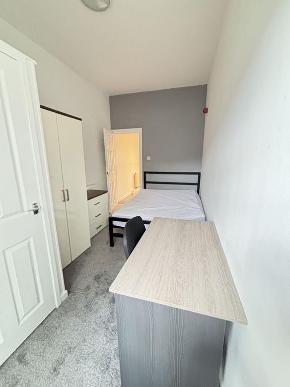 Property photo 1 of 14 A Cozy Bedroom Featuring A Double Bed, A Desk With...