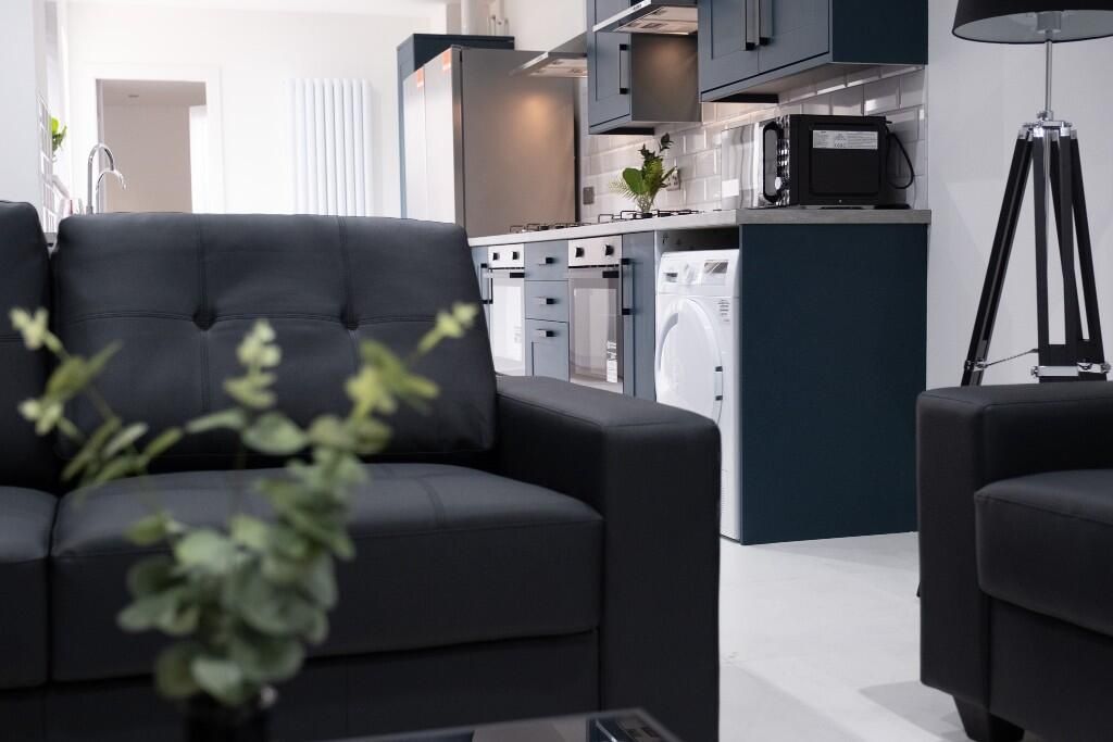 Property photo 3 of 13 Contemporary Living Room With Sleek Dark Sofas In ...