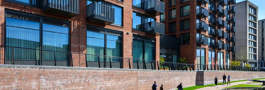 Property photo 1 of 5 Exterior View Of Canal And Walkway In The Sun, With New Build Flats Alongside.