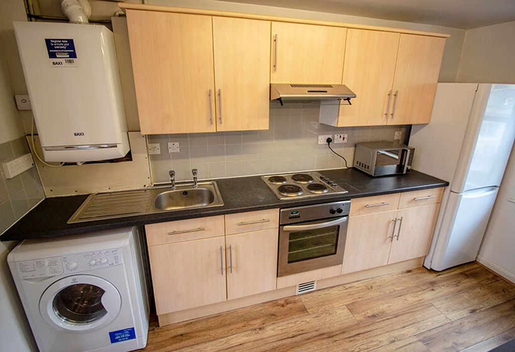 Property photo 3 of 3 Bright And Modern Kitchen Featuring Ample Storage ...