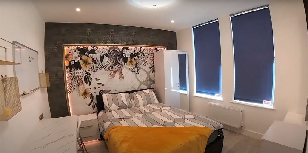 Property photo 2 of 14 A Spacious And Modern Bedroom Featuring A Large Be...
