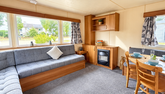 Property photo 1 of 12 Spacious Open Plan Living Area With L Shaped Sofa, Fireplace And Dining Space In The Abi Elegance