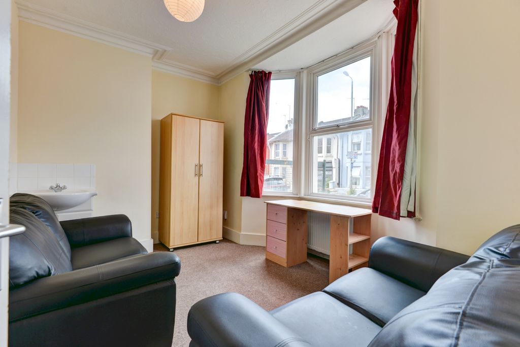 Property photo 3 of 11 A Well-Lit, Inviting Living Room Featuring Comfort...